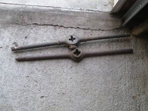 Antique metal pipe threader and decorative tree branch