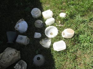 Variety of vintage glass lampshades and vases