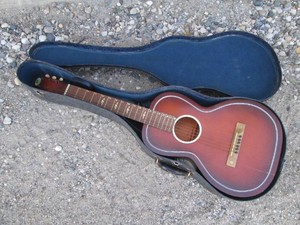 Vintage wood Regal guitar in hardside case with sheet music Needs work