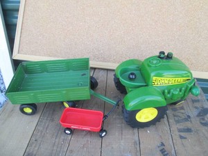 Ertl plastic John Deere tractor, Ertl die cast replica hay wagon and Radio Flyer toy wagon