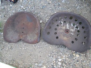 Pair of vintage metal tractor seats