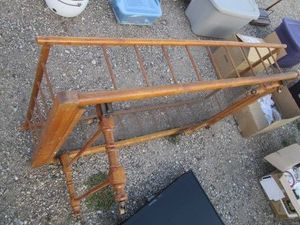 Antique wood framed youth size bed with folding legs