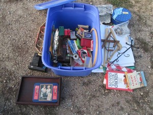 Covered Tote containing a variety of playing cards, misc card games, sewing notions, desktop clock, office supplies, Christmas ornaments, cookbooks and more