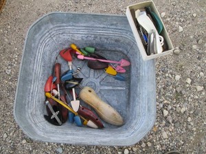 Vintage metal wash tub with a large variety of shoe horns and stretchers