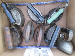 Variety of vintage steam irons and sad irons