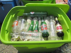 Lidded tote containing a variety of glass soda bottles 1