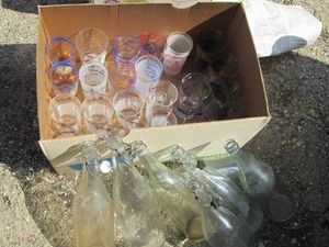 Vintage glass soda bottles and assorted glass cups