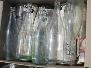 Vintage glass soda bottles with metal hardware tops