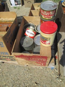 Vintage metal coffee tins in wood crate