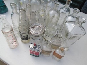Vintage clear bottle variety with tin