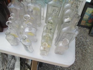Vintage glass bottles in varying sizes and styles