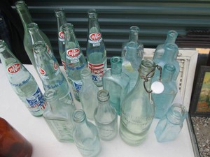 Collection of vintage glass bottles in blue and green tones