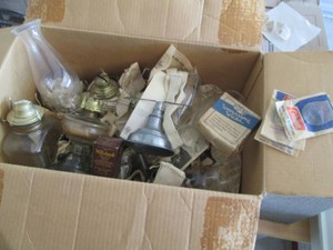 Box of assorted vintage oil lamps, lanterns and shades