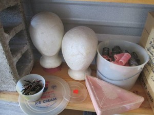 Styrofoam mannequin heads with vintage hair curlers, picks and Bobby pins