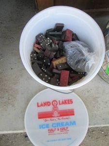 Ice cream bucket full of vintage domino tiles