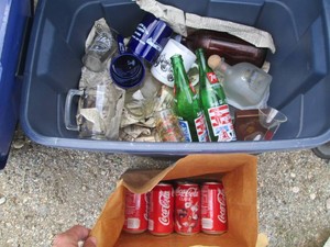 Wide variety of vintage mugs, bottles, glass cups and cans in covered tote