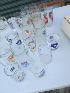 Vintage glass sports themed tankards and assorted size glasses