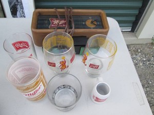 Vintage Miller High Life clock with assorted Miller and Schlitz glassware