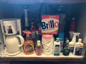Cleaning items - Brillo pads, glass cleaner, garbage bags and more all in cupboard