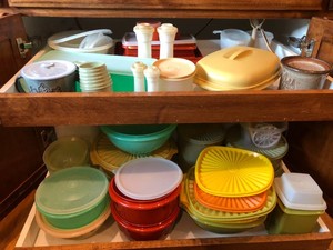 MN wild rice pottery dish and assorted plastic and Tupperware containers, measuring cups, salt and pepper shakers