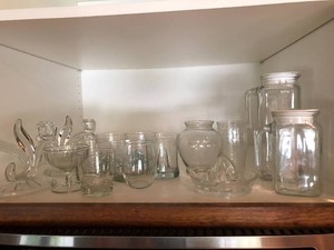 Glass juicer, candle holders, pitchers, glasses and stemware all in 2 cupboards