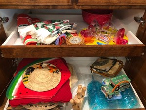 Placemats, hand towels, stemware, plastic margarita glasses and more all in cupboard