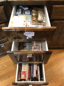 Notepads, playing cards, flashlights, envelopes, cookbooks all in 3 drawers