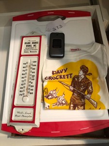Cutting board, thermometer, flip phone, Davy Crockett shirt