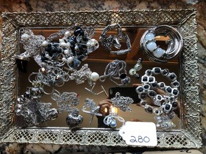 Mirrored tray with necklaces and bracelets