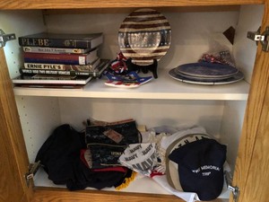 Military items - books, hats, flags and more all in cupboard