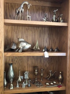 Assorted brass items all on 3 shelves