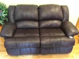 Leather like loveseat, both sides recline