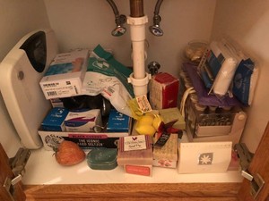 Bathroom items - scale, soap, hot rollers, blood pressure cuff, wrist splint and more all in cupboard and drawer