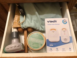 Heating pad, digital audio monitor, candle all in drawer