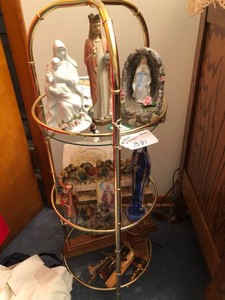 Metal and glass stand with religious items