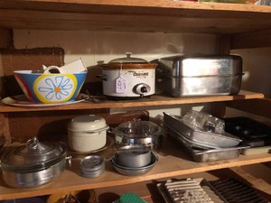 Crockpot, roaster, cake and muffin pans all on two shelves