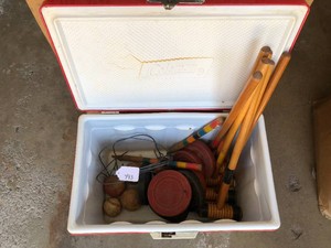 Croquet set and  Wilson pucks in a Coleman cooler