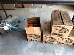 Clay target thrower and 4 boxes of clay targets, not all full