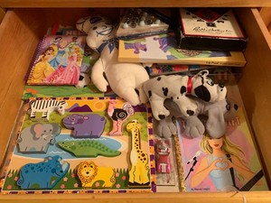 Kids toys, puzzles, stuffed animals, books, Monopoly game all in drawer