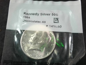 Uncirculated bright and beautiful 1964 Kennedy Half Dollar in sealed tab (90% Silver)