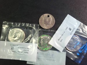 (1) 1964 Half Dollar (punched for jewelry) and (3) Uncirculated Kennedy Half Dollars