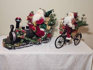 Playful Train and Tricycle Riding Santa Figure Pair