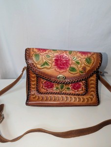 Vintage, hand-tooled leather shoulder bag with an embossed floral and rose design