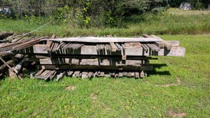 Large pile of sun-dried weathered oak barnwood custom builder project multiple sizes