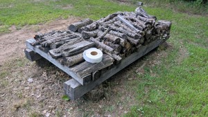 Large pile of kindling or art project. Sun air dried oak rounds and pieces