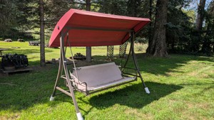 Large deck patio yard swing with feet for moving around the yard. small tear in the back but I sat in it and it works as it should. May need new fabric on the bottom soon. the rest is in excellent condition