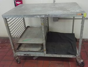 NSF STAINLESS PREP TABLE WITH CASTER WHEELS AND 2 BAKERS PANS