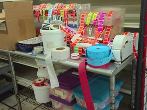 LARGE NSF ROLLING CART FULL OF MISC ASSORTED RETAIL LABELS - STICKERS AND MORE