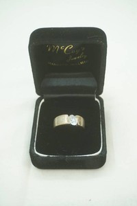 silver toned wide band ring with oval cut stone 