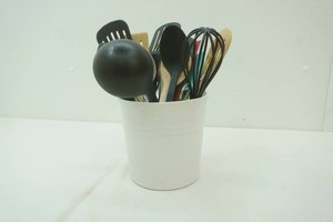 ceramic canister filled with whiskers, spatulas, ladles and more